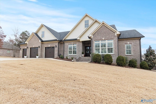 view of front of property featuring a garage and a front lawn