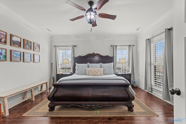 bedroom with crown molding, dark wood-type flooring, and multiple windows