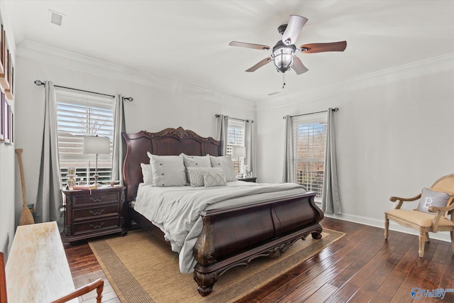 bedroom with ornamental molding, dark wood-type flooring, and ceiling fan