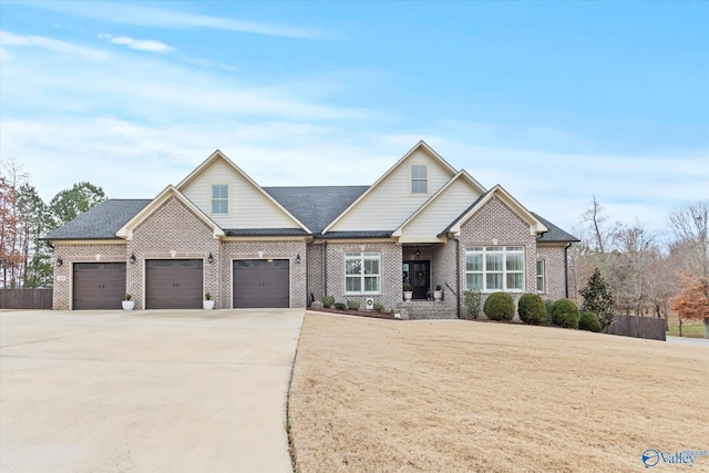 craftsman inspired home featuring a garage and a front lawn