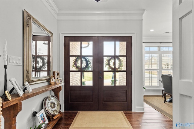 foyer featuring dark hardwood / wood-style flooring, ornamental molding, and french doors