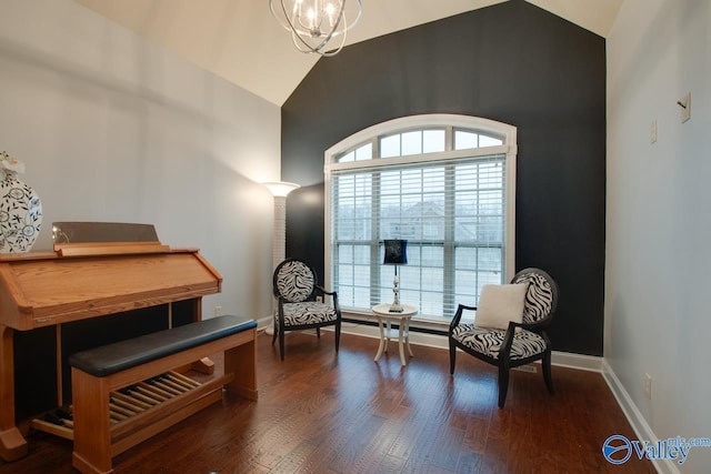 sitting room with dark hardwood / wood-style flooring, lofted ceiling, and an inviting chandelier