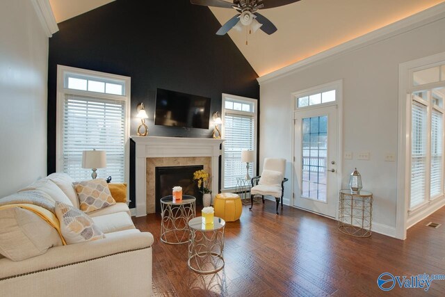 living room with ceiling fan, dark hardwood / wood-style flooring, lofted ceiling, and a wealth of natural light