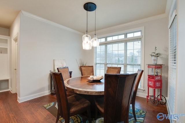 dining area with dark hardwood / wood-style floors, ornamental molding, and a chandelier