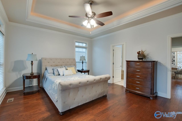 bedroom featuring dark hardwood / wood-style flooring, a raised ceiling, ceiling fan, and crown molding