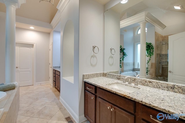 bathroom featuring vanity, independent shower and bath, and decorative columns