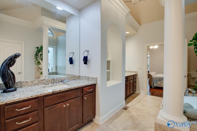 bathroom featuring vanity, crown molding, and decorative columns