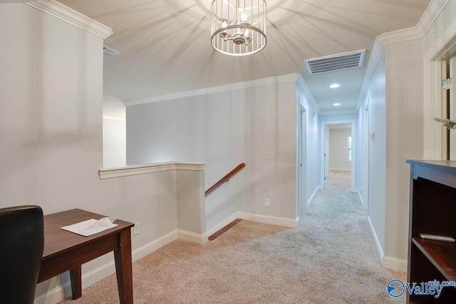 hall featuring crown molding, light colored carpet, and an inviting chandelier