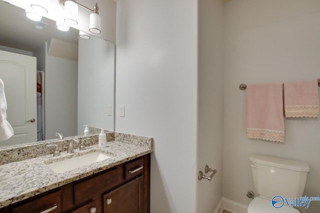 bathroom featuring vanity and toilet