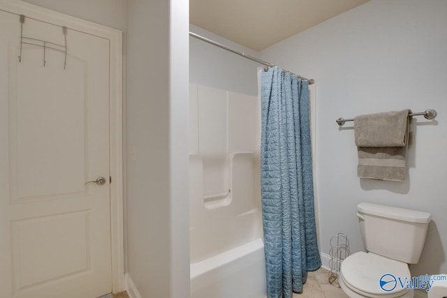 bathroom featuring shower / tub combo, toilet, and tile patterned floors