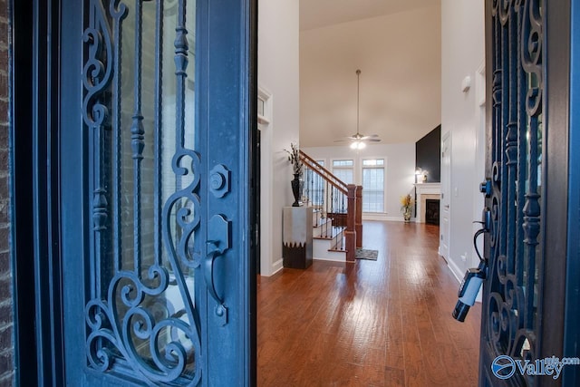 entrance foyer with hardwood / wood-style flooring, high vaulted ceiling, and ceiling fan