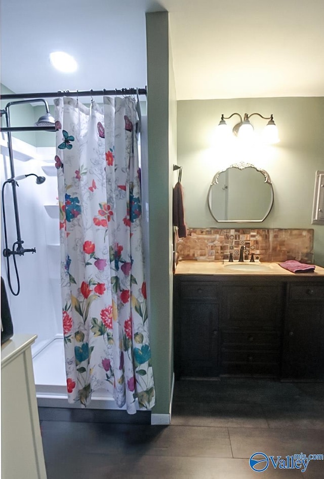 bathroom with vanity, curtained shower, and tasteful backsplash