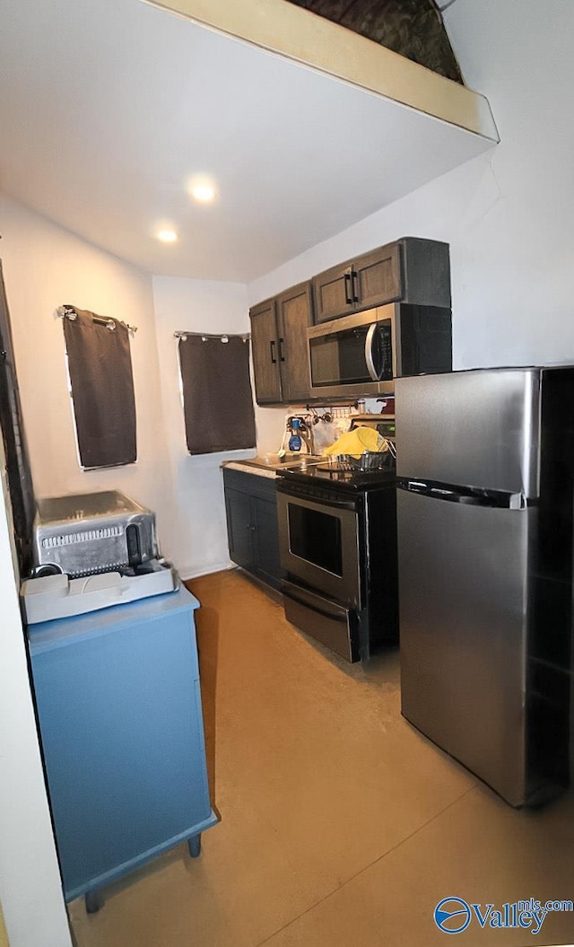 kitchen with stainless steel appliances and dark brown cabinets