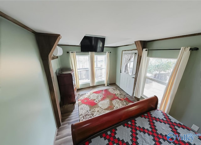 bedroom featuring hardwood / wood-style flooring and an AC wall unit