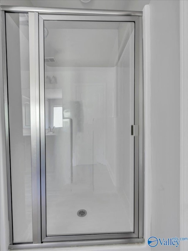 bathroom featuring a shower stall and visible vents
