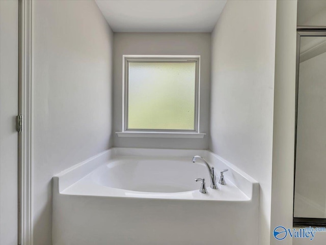 bathroom with a garden tub
