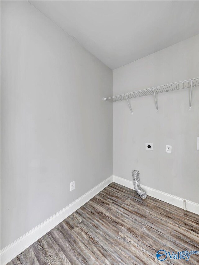 laundry area featuring hookup for an electric dryer, wood finished floors, laundry area, and baseboards