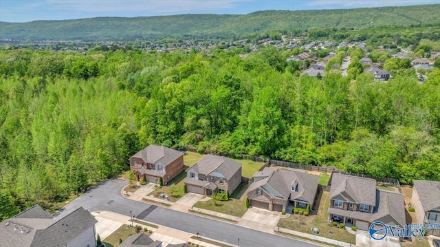 birds eye view of property featuring a residential view and a wooded view