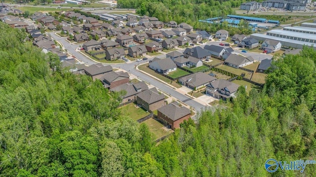birds eye view of property with a forest view and a residential view