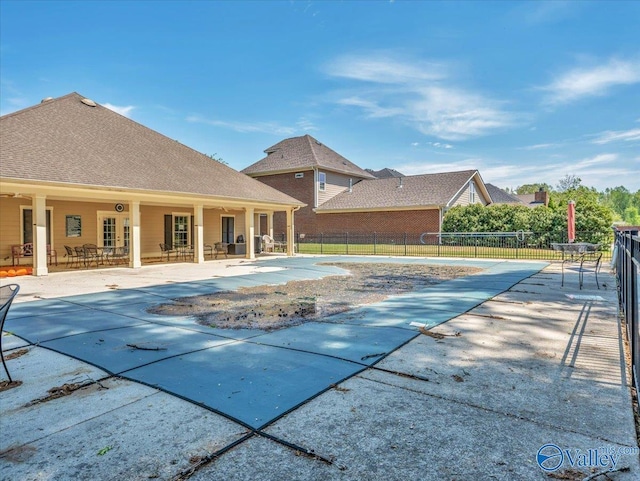 view of pool featuring fence and a patio area
