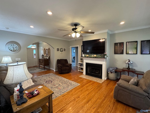 3648 Turnpike Rd, Albertville, AL 35950 - living room with arched walkways, ceiling fan, recessed lighting, light wood-type flooring, and a tile fireplace