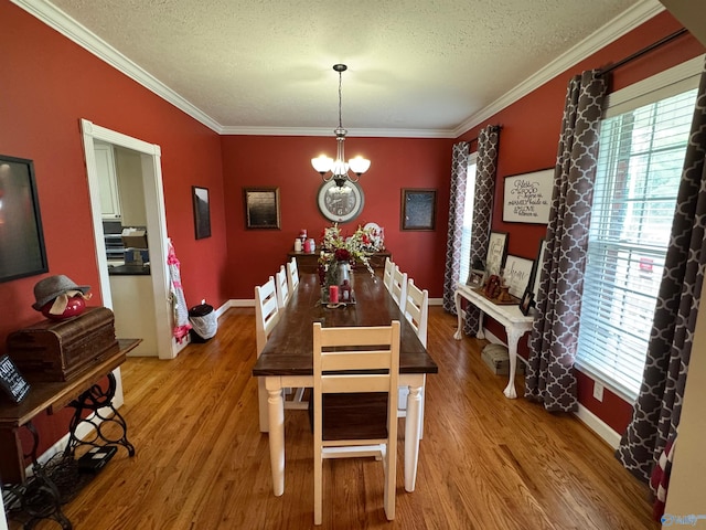 3648 Turnpike Rd, Albertville, AL 35950 - dining room with plenty of natural light, wood finished floors, crown molding, a textured ceiling, and a chandelier