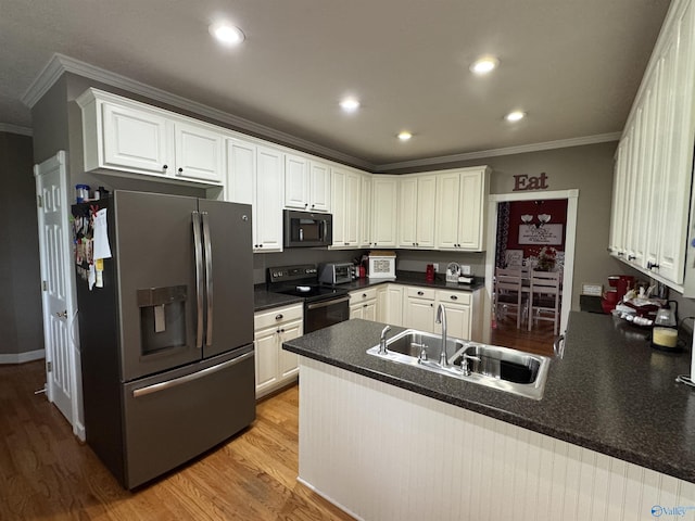 3648 Turnpike Rd, Albertville, AL 35950 - kitchen featuring black appliances, a sink, ornamental molding, a peninsula, and light wood-style flooring