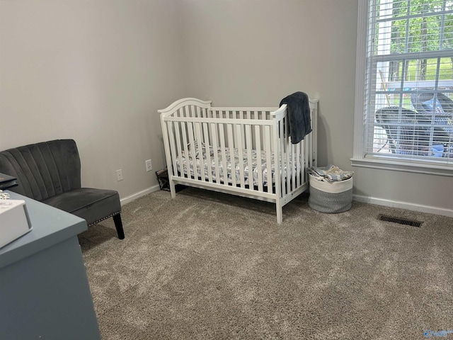 3648 Turnpike Rd, Albertville, AL 35950 - carpeted bedroom with baseboards and a crib