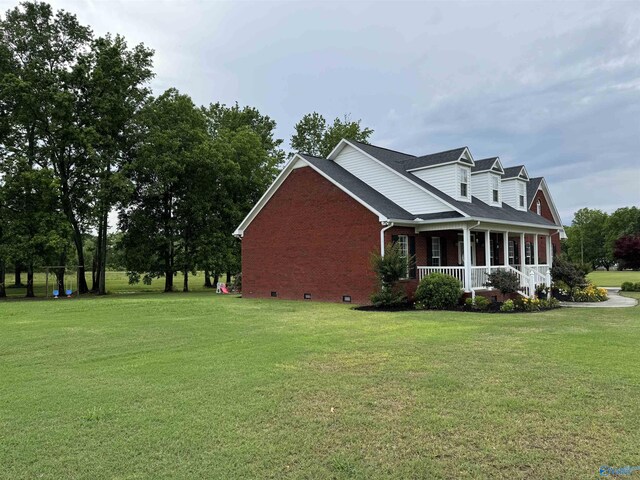 3648 Turnpike Rd, Albertville, AL 35950 - view of side of property featuring covered porch, a lawn, brick siding, and crawl space