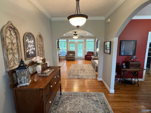 3648 Turnpike Rd, Albertville, AL 35950 - foyer featuring arched walkways, wood finished floors, ornamental molding, a ceiling fan, and a textured ceiling