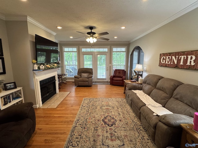 3648 Turnpike Rd, Albertville, AL 35950 - living area featuring ceiling fan, light wood-style floors, recessed lighting, a tile fireplace, and ornamental molding
