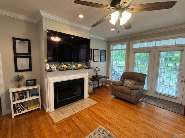3648 Turnpike Rd, Albertville, AL 35950 - living area featuring light wood-style flooring, ceiling fan, a fireplace with flush hearth, crown molding, and recessed lighting