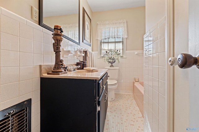 bathroom featuring tile patterned floors, vanity, toilet, and tile walls