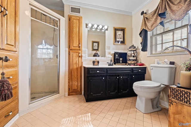 bathroom featuring tile patterned flooring, toilet, vanity, a shower with shower door, and ornamental molding