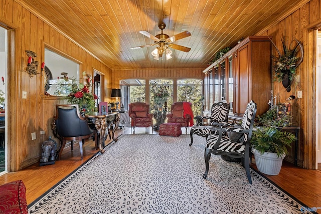 sunroom featuring ceiling fan and wooden ceiling