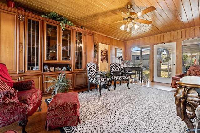 sunroom / solarium featuring ceiling fan and wood ceiling