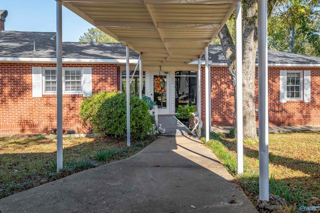 entrance to property featuring a yard