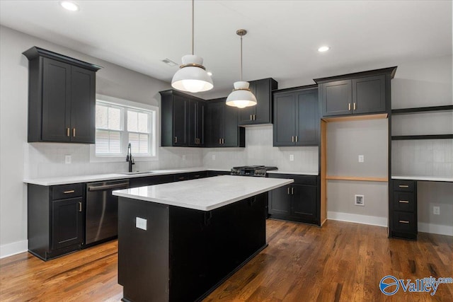 kitchen featuring tasteful backsplash, a kitchen island, hanging light fixtures, and dishwashing machine