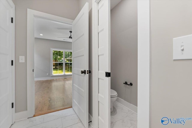 bathroom featuring ceiling fan and toilet