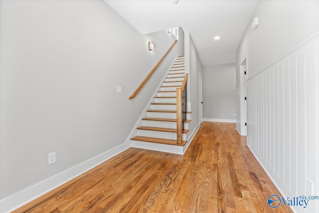 staircase with hardwood / wood-style flooring