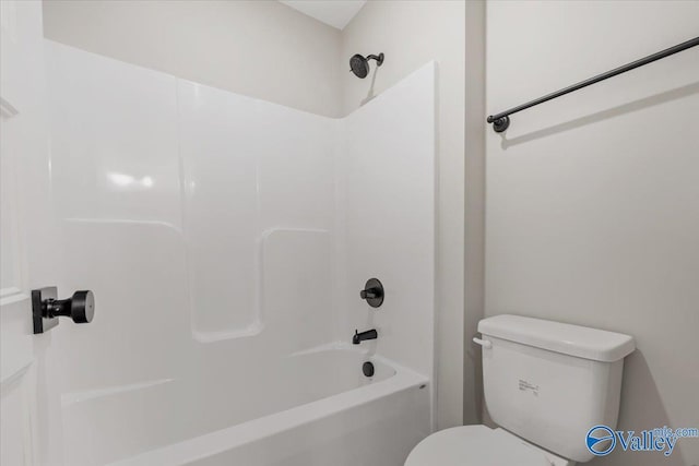 bathroom featuring shower / washtub combination and toilet