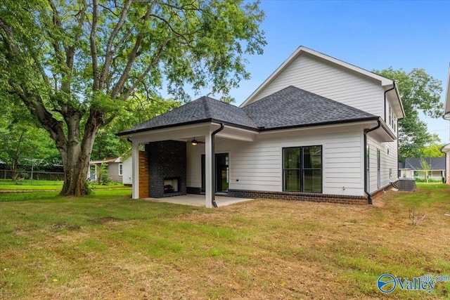 back of house with a yard and a patio