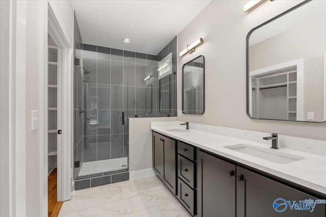 bathroom with vanity and a shower with shower door