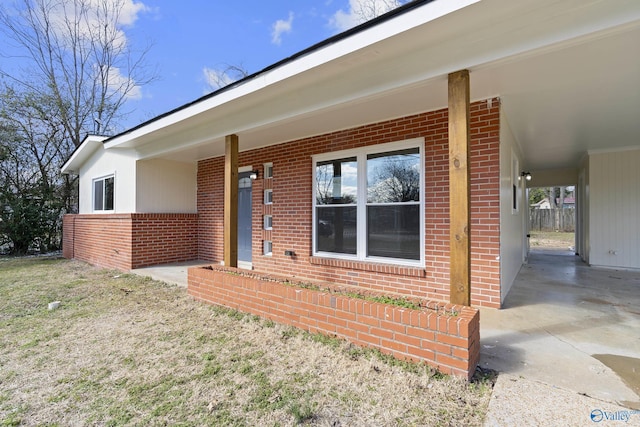 doorway to property featuring brick siding