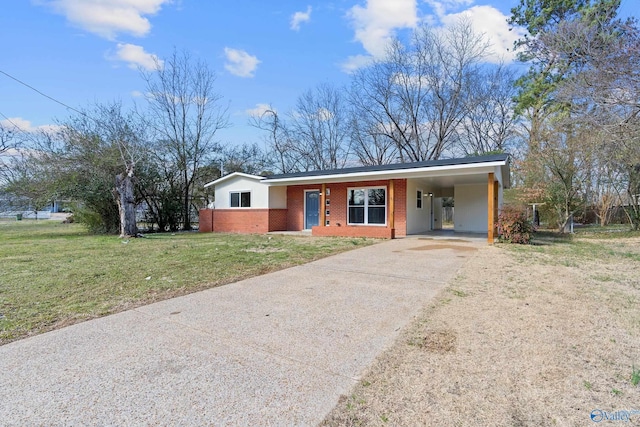 ranch-style house with a carport, driveway, brick siding, and a front yard