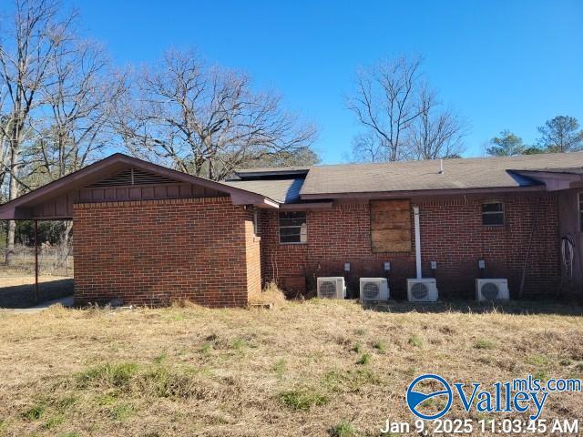 view of side of property featuring ac unit