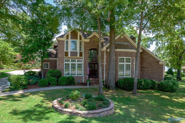 tudor house featuring a front lawn