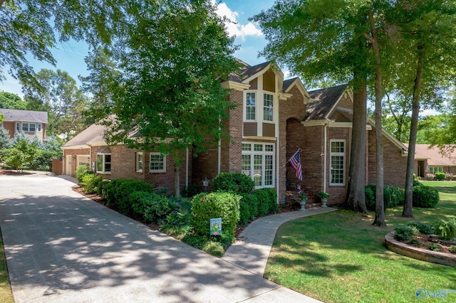 english style home featuring a garage