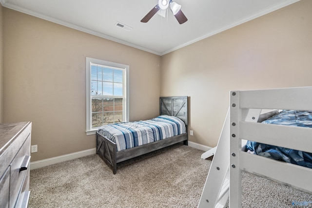 bedroom featuring carpet floors, visible vents, crown molding, and baseboards