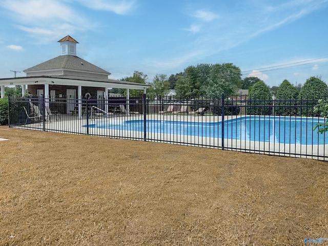 community pool featuring a patio area and fence